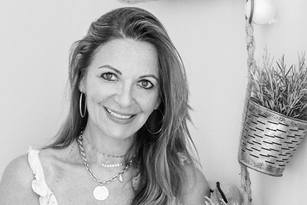 Smiling black and white portrait of the host, Anne Bernard