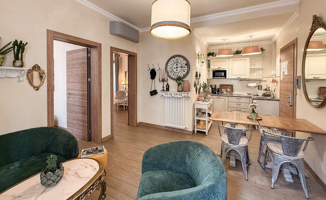 Dining area at Madonna del Terraglio with green velvet armchairs and metal chairs around the table
